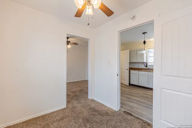a view of a kitchen from the hallway