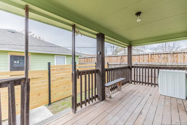 a view of a balcony with wooden floor