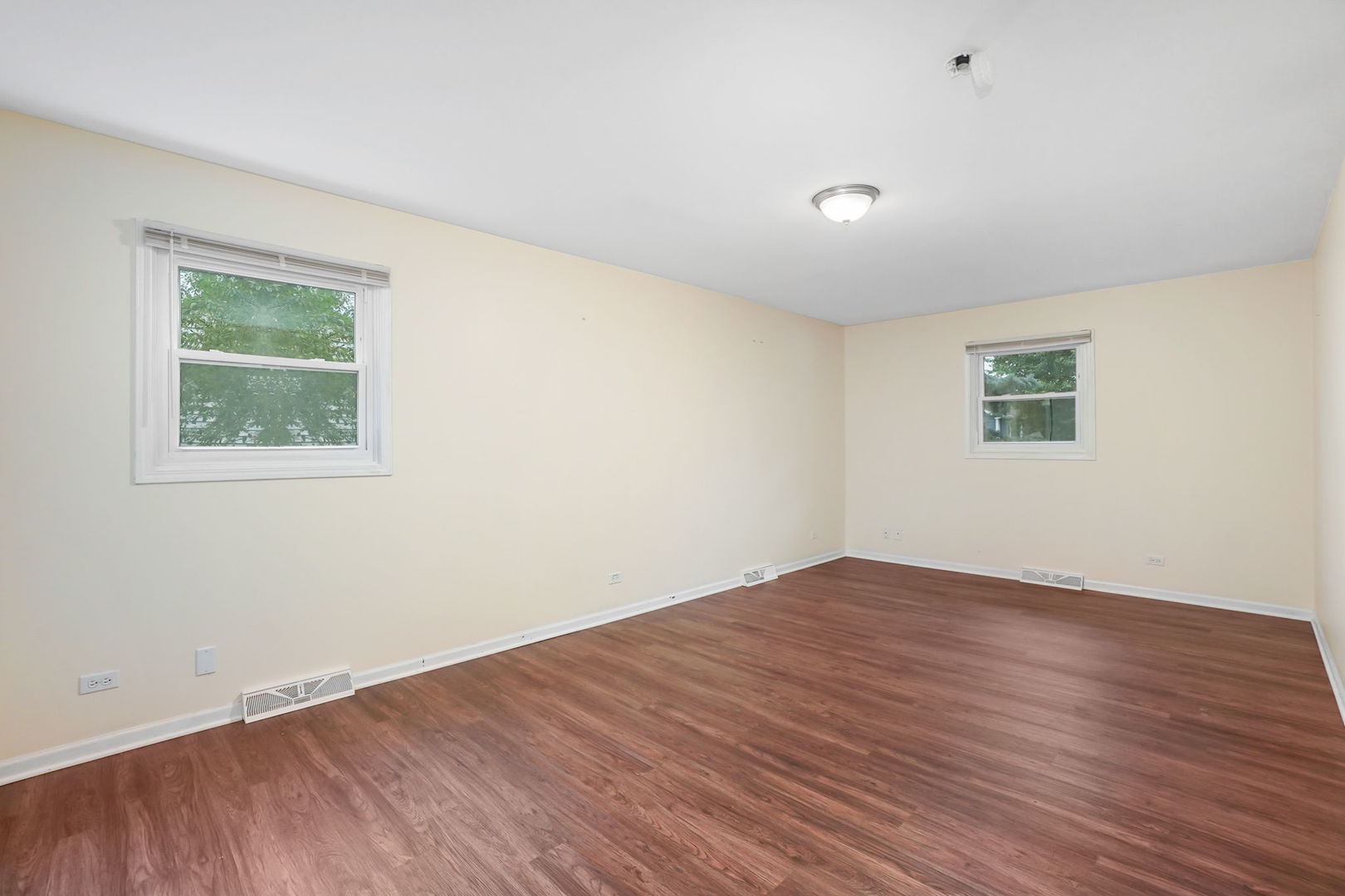 2165 Savannah Road Elgin, IL 60123 - Photo 11 of 27 an empty room with wooden floor and windows