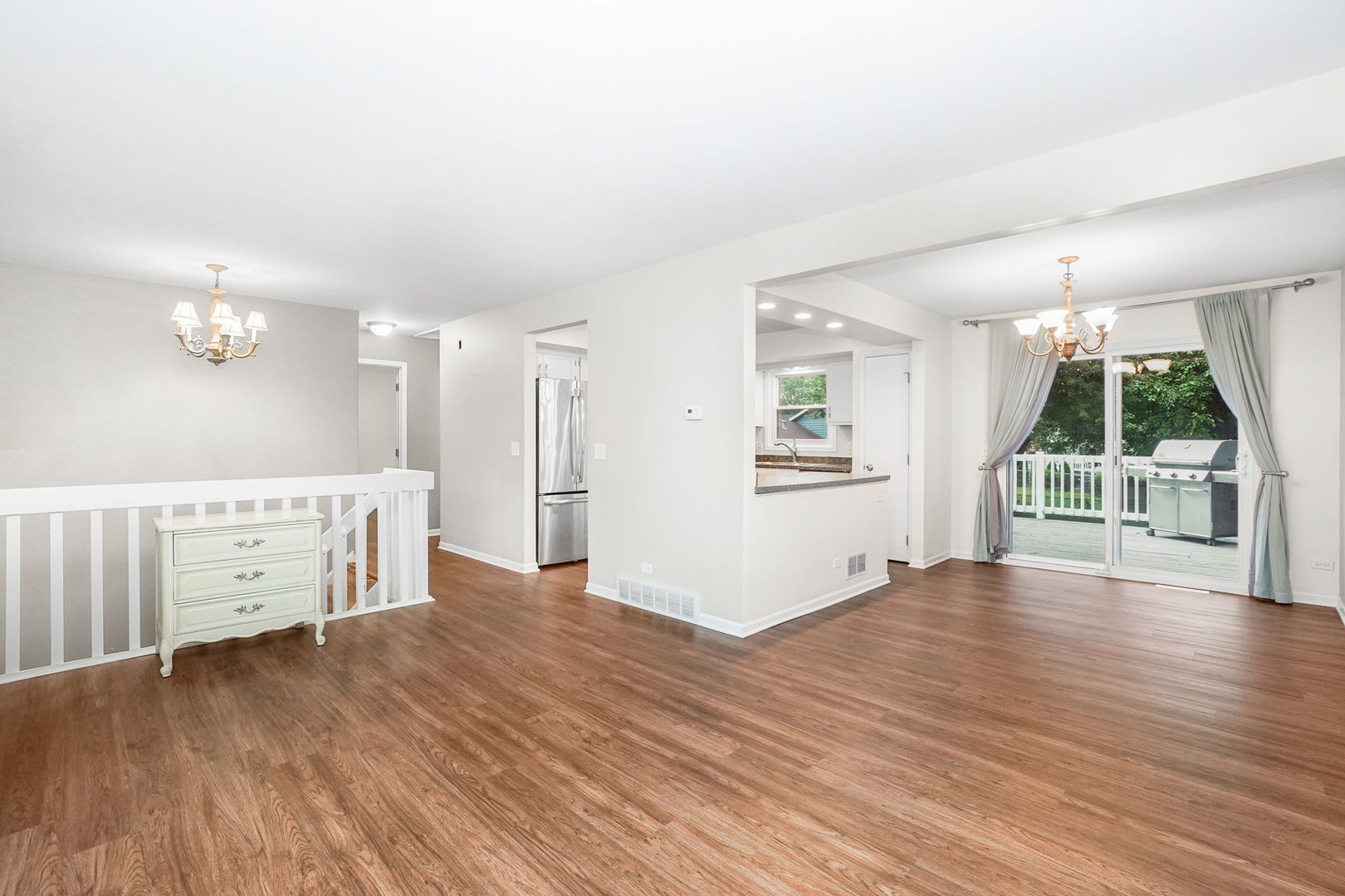 2165 Savannah Road Elgin, IL 60123 - Photo 2 of 27 an empty room with wooden floor and windows
