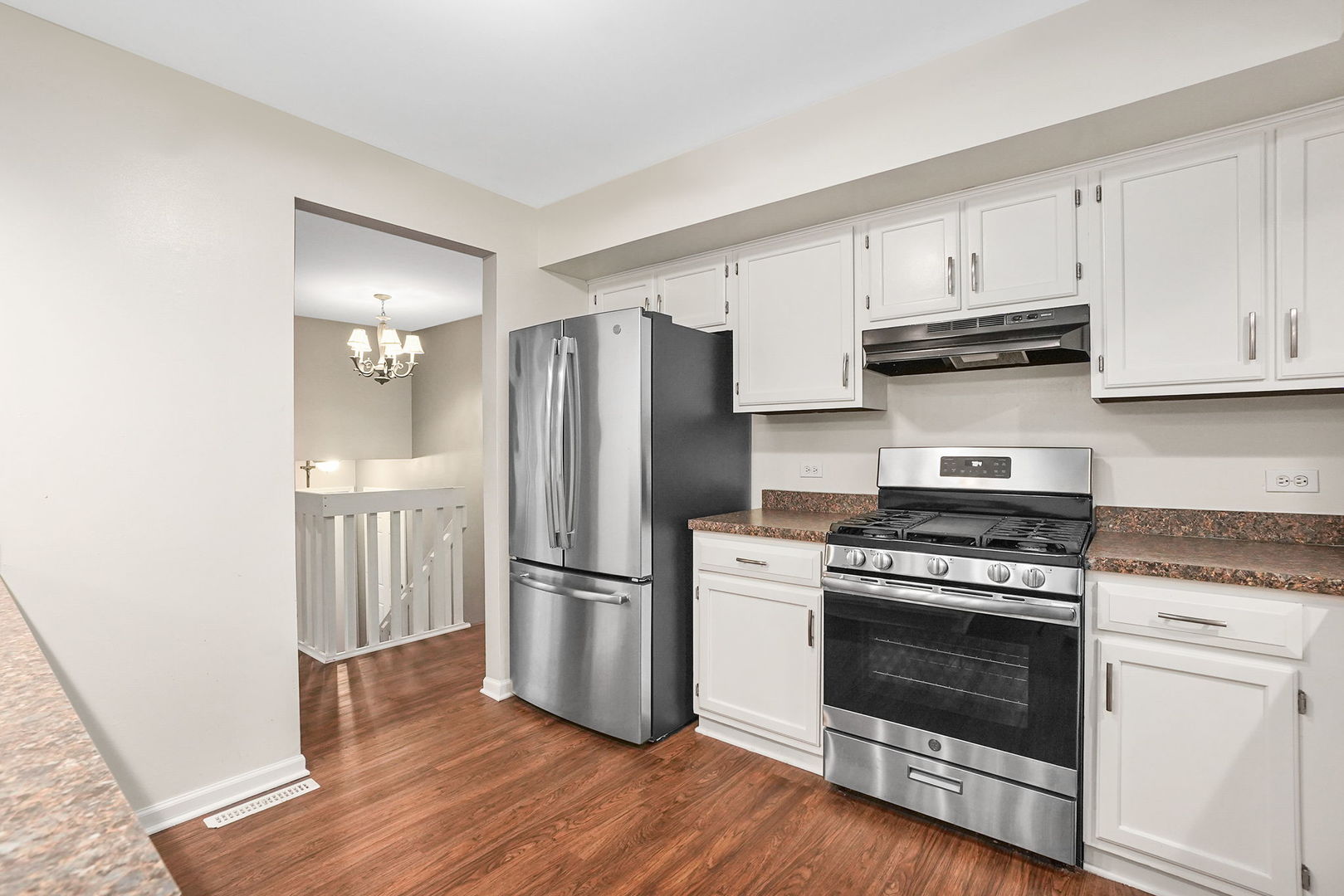 2165 Savannah Road Elgin, IL 60123 - Photo 5 of 27 a kitchen with wooden floors and stainless steel appliances