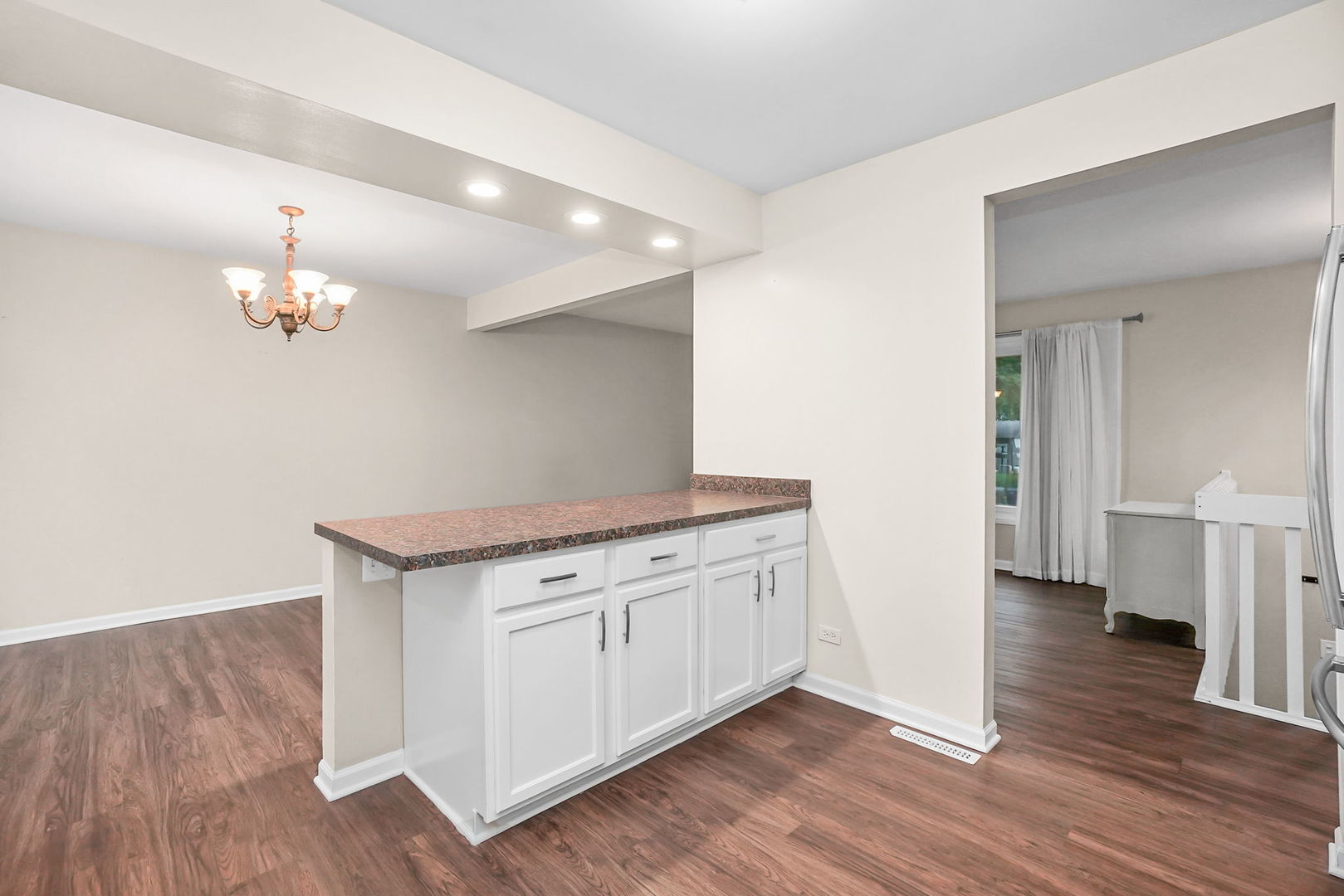 2165 Savannah Road Elgin, IL 60123 - Photo 7 of 27 a view of a hallway with wooden floor and chandelier