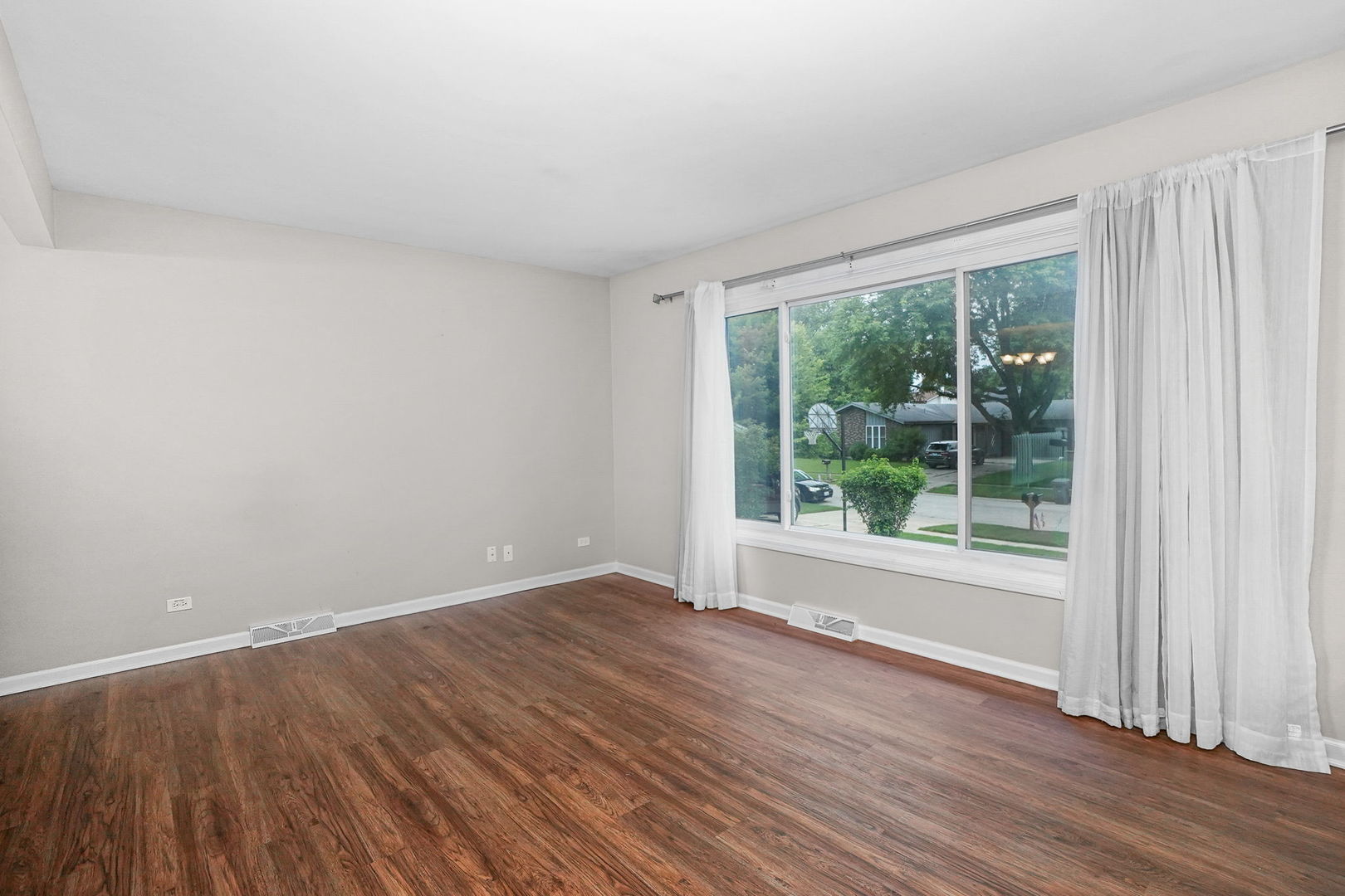 2165 Savannah Road Elgin, IL 60123 - Photo 9 of 27 an empty room with wooden floor and windows