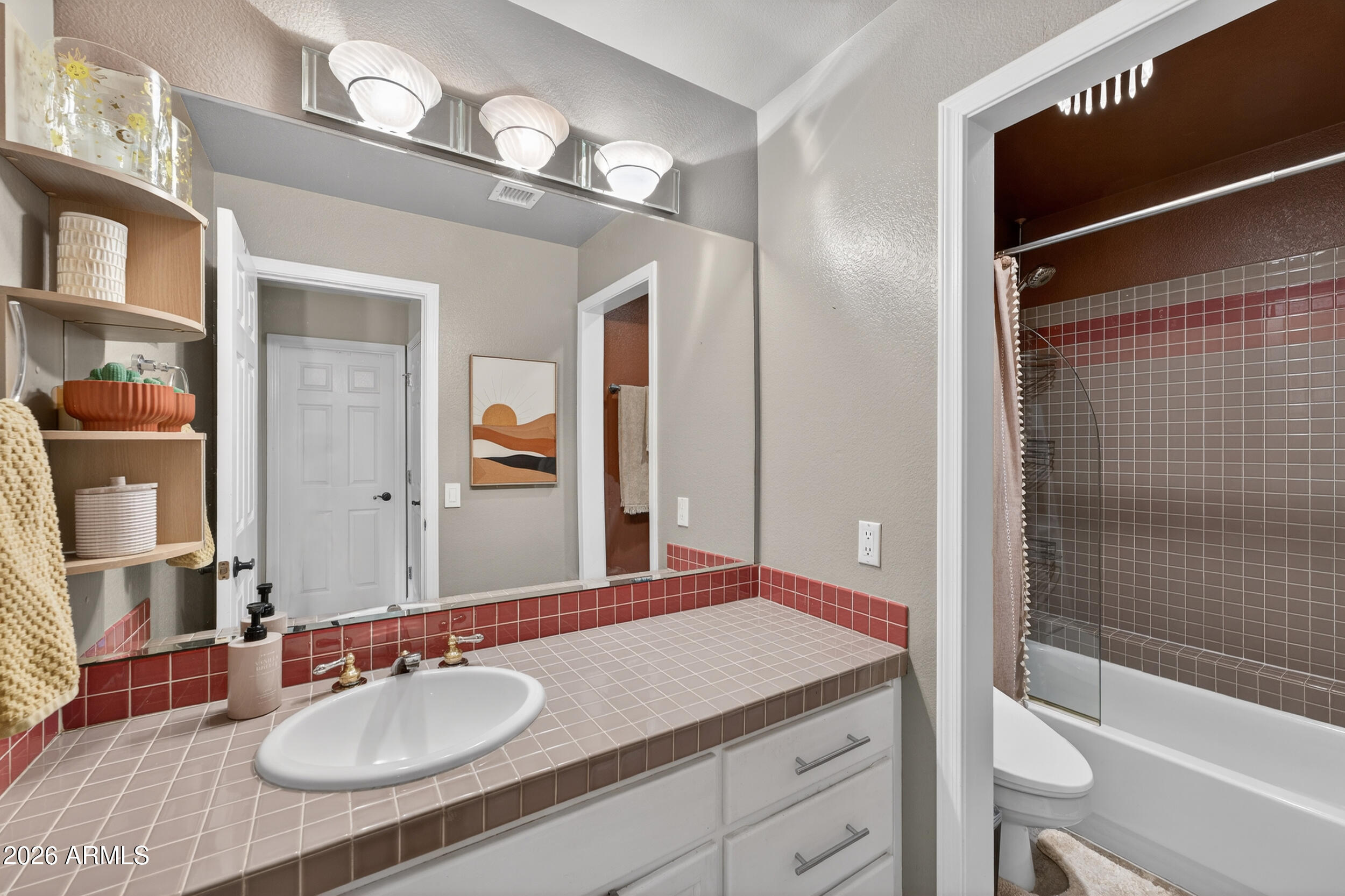 1539 East Winged Foot Road Phoenix, AZ 85022 - Photo 45 of 64 a bathroom with a granite countertop sink a toilet a mirror and shower