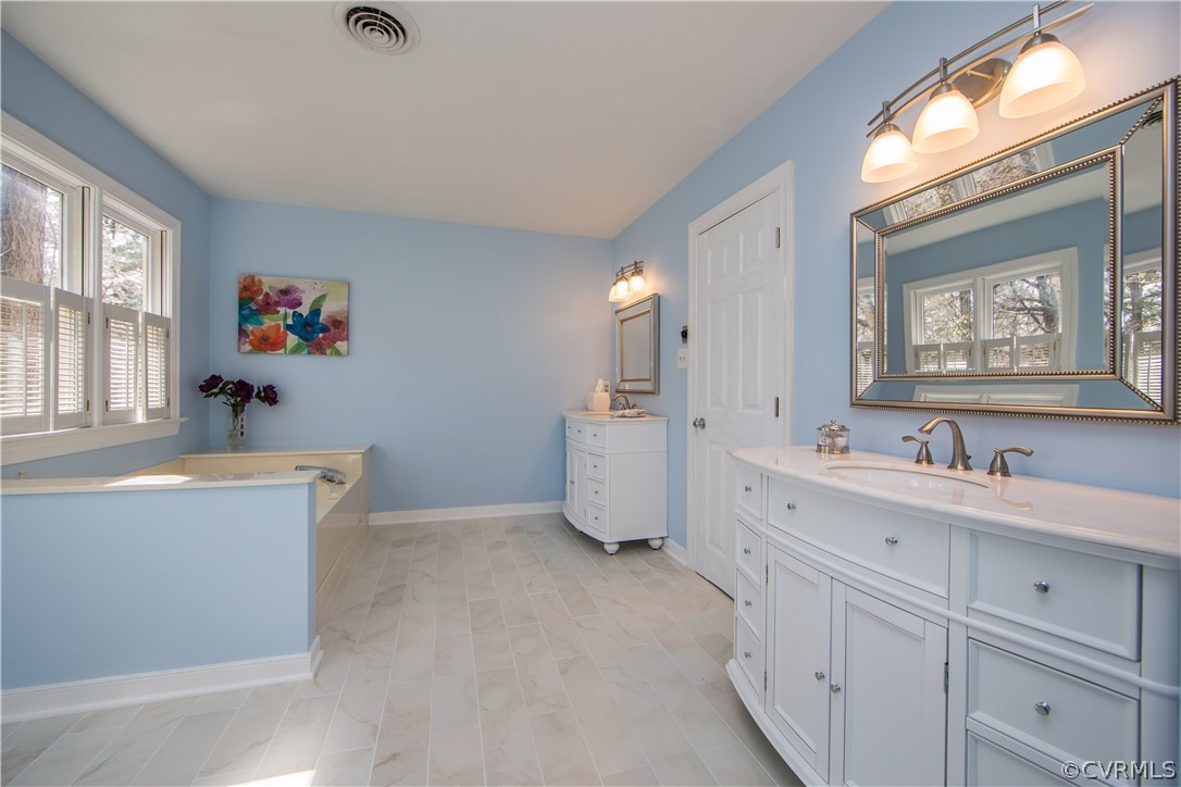 14430 West Salisbury Road Midlothian, VA 23113 - Photo 21 of 36 a spacious bathroom with a tub sink and mirror