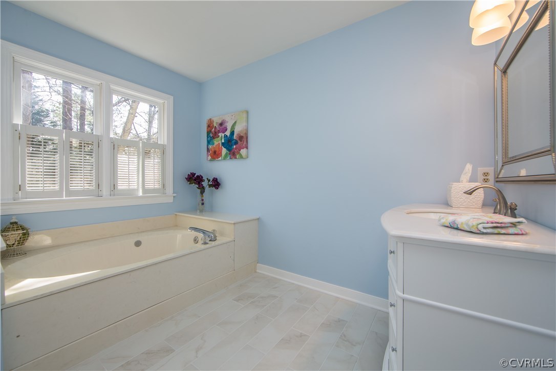 14430 West Salisbury Road Midlothian, VA 23113 - Photo 22 of 36 a bathroom with a tub a sink and a window