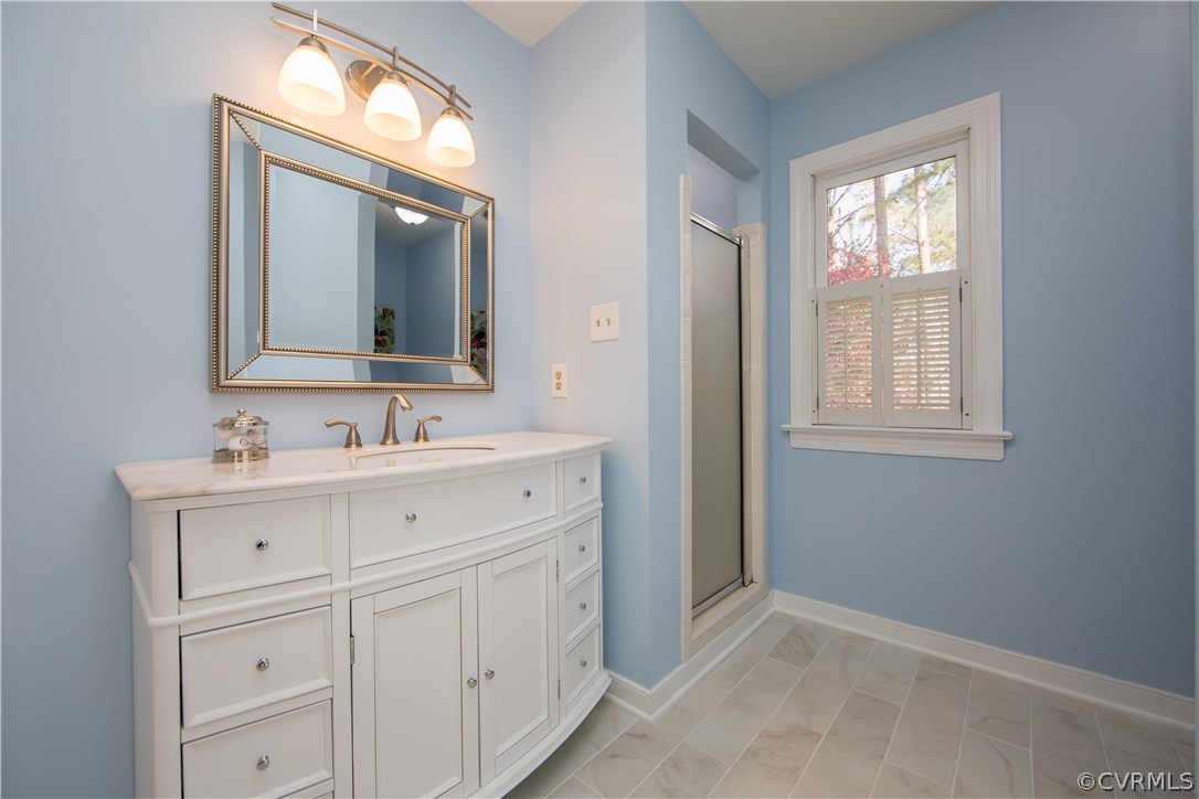 14430 West Salisbury Road Midlothian, VA 23113 - Photo 23 of 36 a bathroom with a sink mirror and a window
