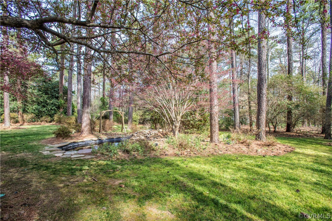14430 West Salisbury Road Midlothian, VA 23113 - Photo 31 of 36 a backyard of a house with lots of green space and fountain