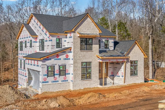 a view of a house with a patio and a yard