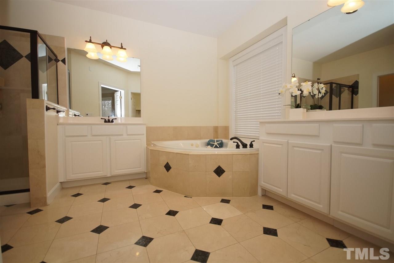 12520 Amoretto Way Raleigh, NC 27613 - Photo 16 of 25 a bathroom with a sink mirror and vanity