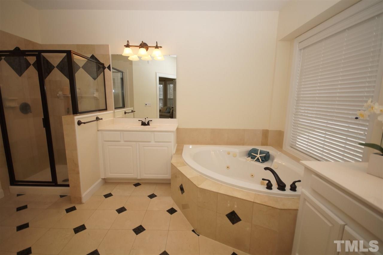 12520 Amoretto Way Raleigh, NC 27613 - Photo 17 of 25 a bathroom with a sink a toilet and shower