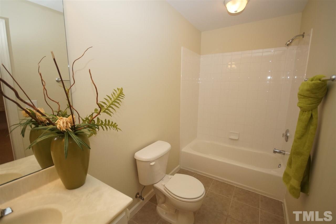 12520 Amoretto Way Raleigh, NC 27613 - Photo 19 of 25 a bathroom with a toilet and a shower