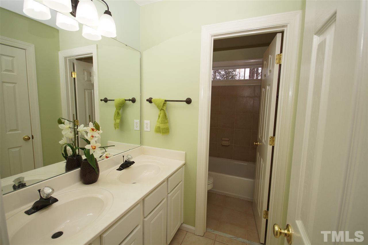 12520 Amoretto Way Raleigh, NC 27613 - Photo 23 of 25 a bathroom with a sink a toilet and shower