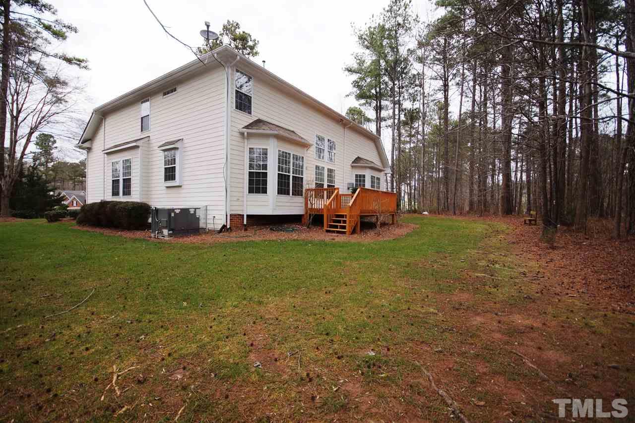 12520 Amoretto Way Raleigh, NC 27613 - Photo 25 of 25 a front view of a house with a yard and trees