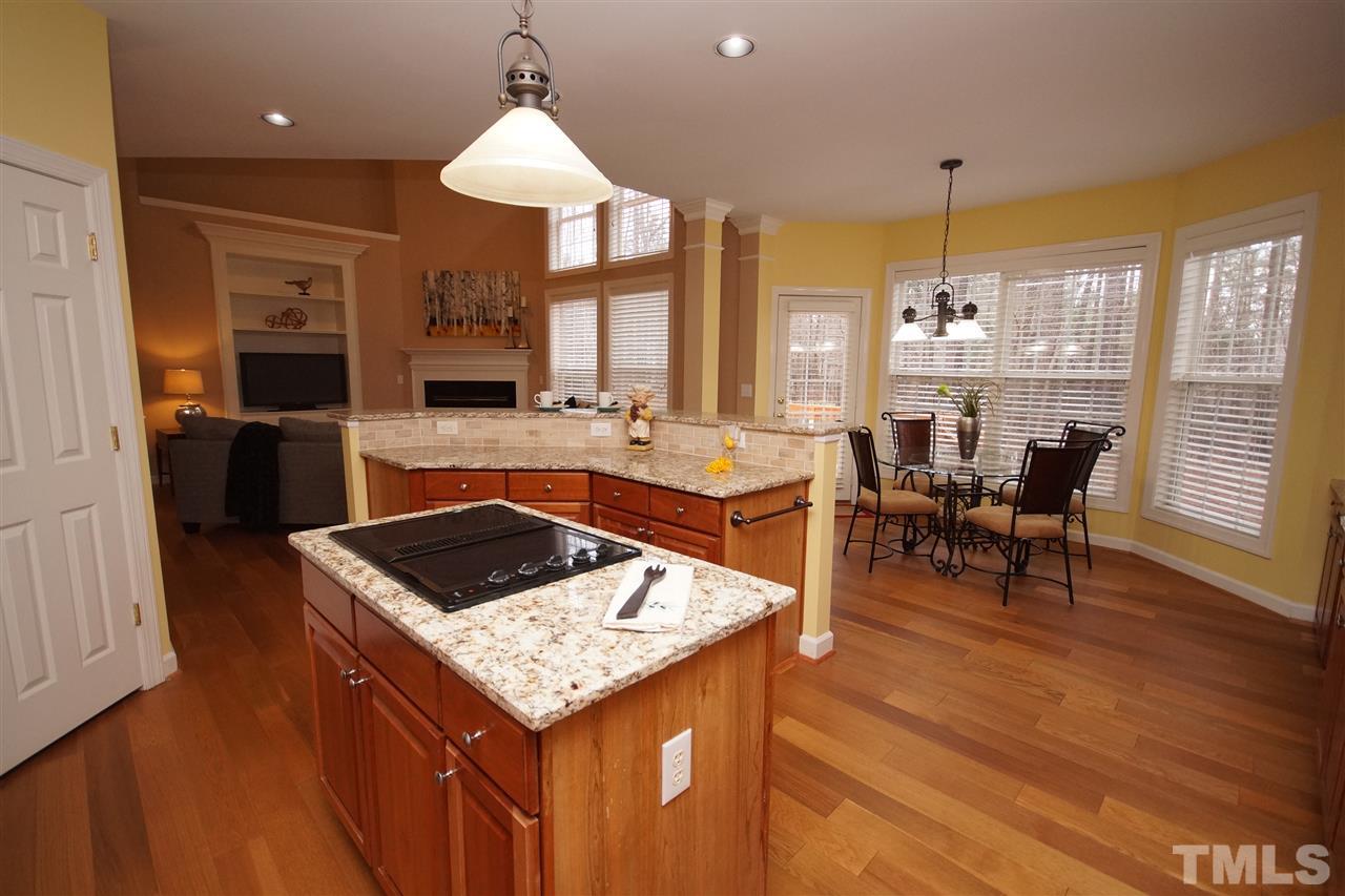 12520 Amoretto Way Raleigh, NC 27613 - Photo 9 of 25 a kitchen with a table chairs stove and kitchen view