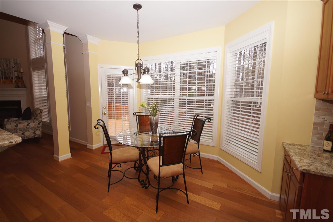 12520 Amoretto Way Raleigh, NC 27613 - Photo 10 of 25 a view of a dining room with furniture window and wooden floor