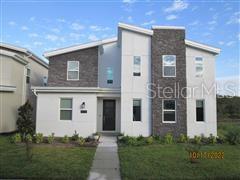 a view of a white house next to a yard