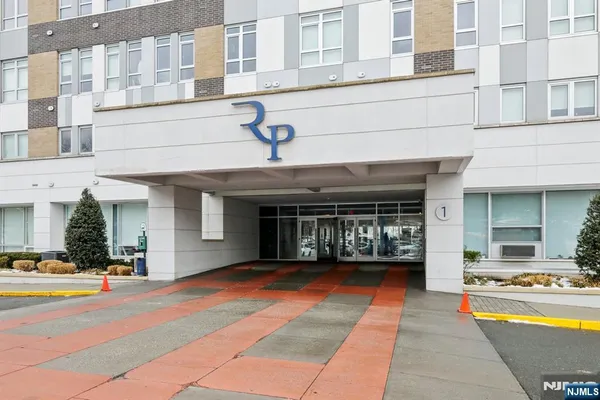 a view of a building with car parked