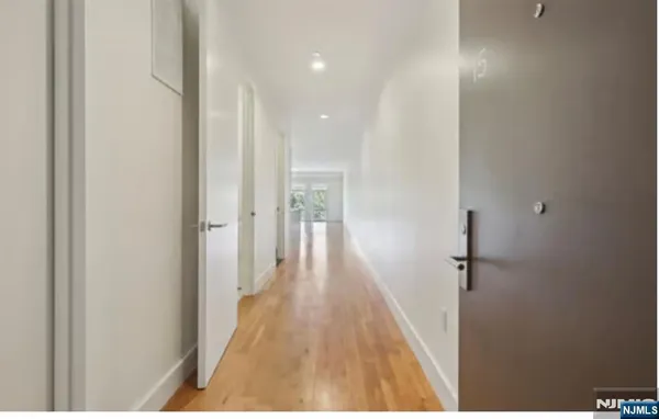 a view of hallway with wooden floor