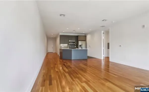 a view of kitchen and wooden floor