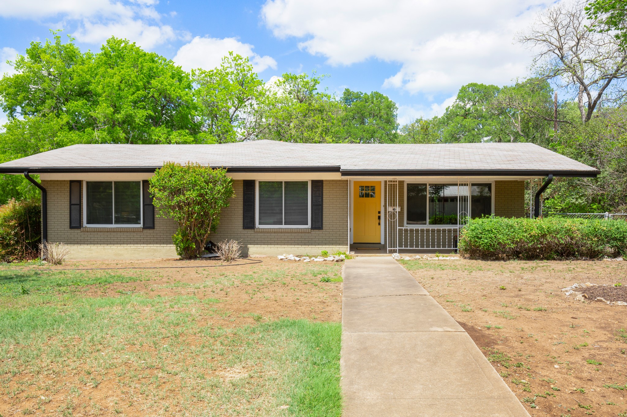 4702 Lasso Path Austin, TX 78745 - Photo 30 of 34 a front view of a house with a yard and potted plants