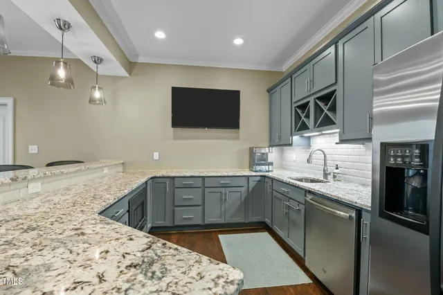 a living room with furniture chandelier and a fireplace