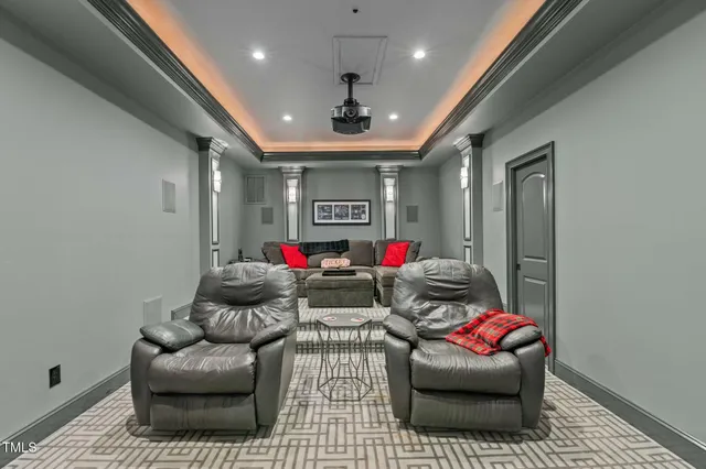 a kitchen with stainless steel appliances granite countertop a refrigerator a sink dishwasher a stove and a dining table with wooden floor