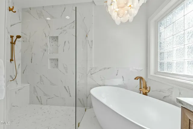 a living room with furniture a fireplace and a large window