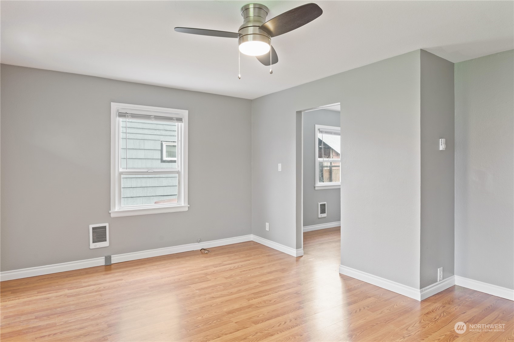 3153 Florida Street Longview, WA 98632 - Photo 11 of 27 a view of an empty room with wooden floor and a window