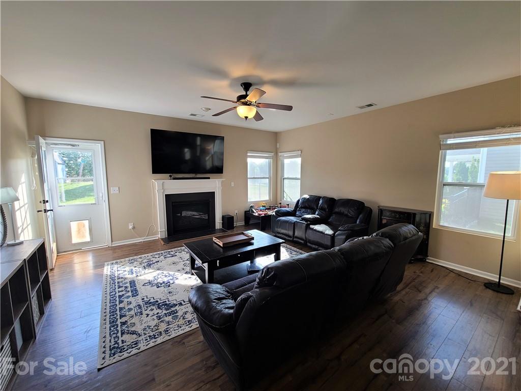 79315 Ridgehaven Road Lancaster, SC 29720 - Photo 13 of 41 a living room with furniture a flat screen tv and a fireplace