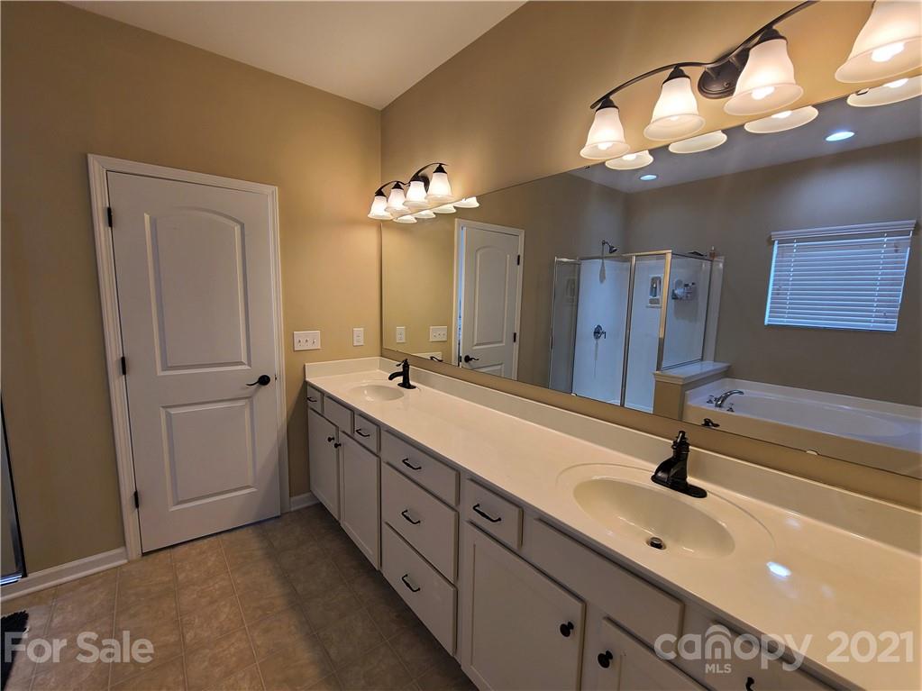 79315 Ridgehaven Road Lancaster, SC 29720 - Photo 17 of 41 a spacious bathroom with a double vanity sink a mirror and shower