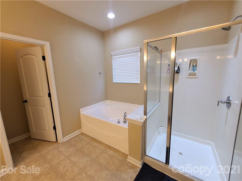 79315 Ridgehaven Road Lancaster, SC 29720 - Photo 18 of 41 a bathroom with a tub shower and a sink