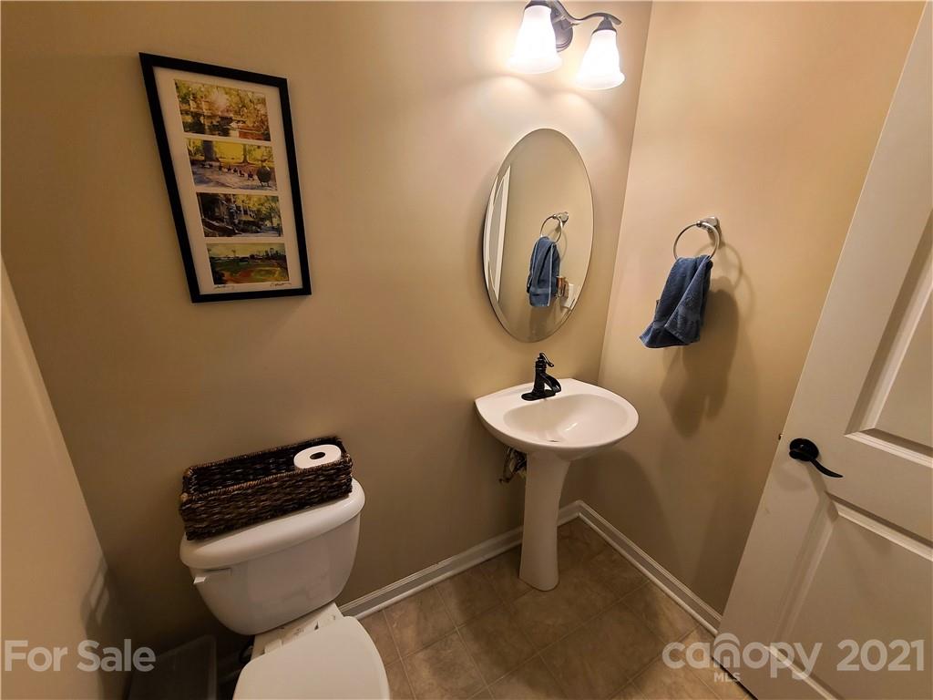 79315 Ridgehaven Road Lancaster, SC 29720 - Photo 20 of 41 a bathroom with a toilet a sink and mirror