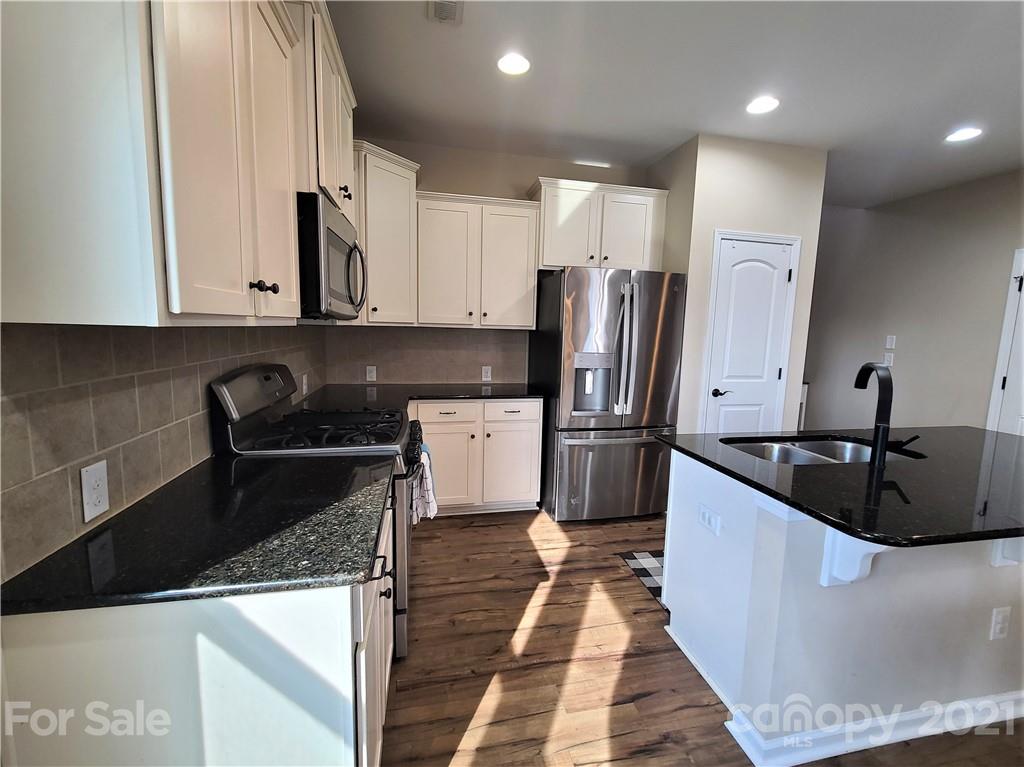 79315 Ridgehaven Road Lancaster, SC 29720 - Photo 3 of 41 a kitchen with stainless steel appliances granite countertop a sink stove and refrigerator