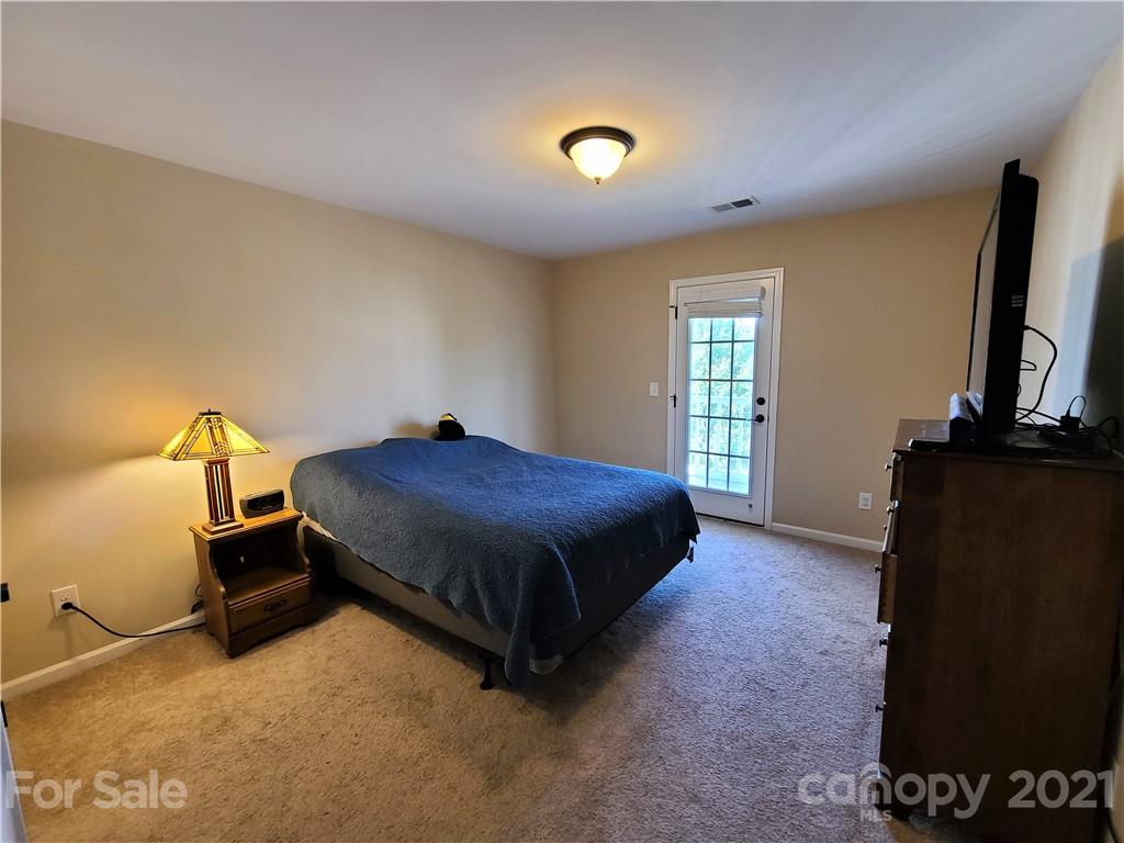 79315 Ridgehaven Road Lancaster, SC 29720 - Photo 27 of 41 a spacious bedroom with a bed and a flat screen tv