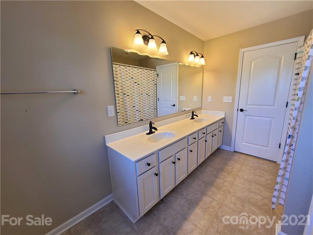 79315 Ridgehaven Road Lancaster, SC 29720 - Photo 30 of 41 a bathroom with a double vanity sink a and a mirror