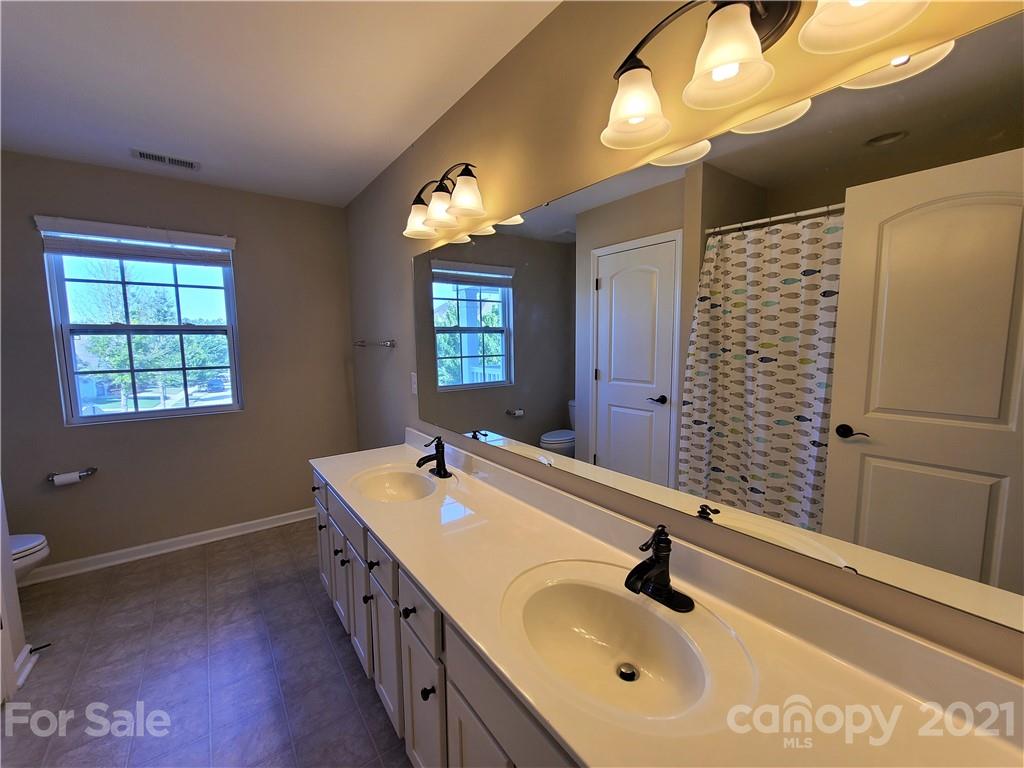 79315 Ridgehaven Road Lancaster, SC 29720 - Photo 31 of 41 a bathroom with a double vanity sink and a mirror