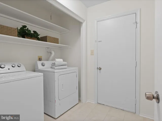 a view of washer and dryer with kitchen in the background