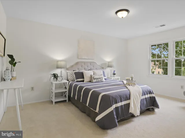 a bedroom with two beds and painting on the wall
