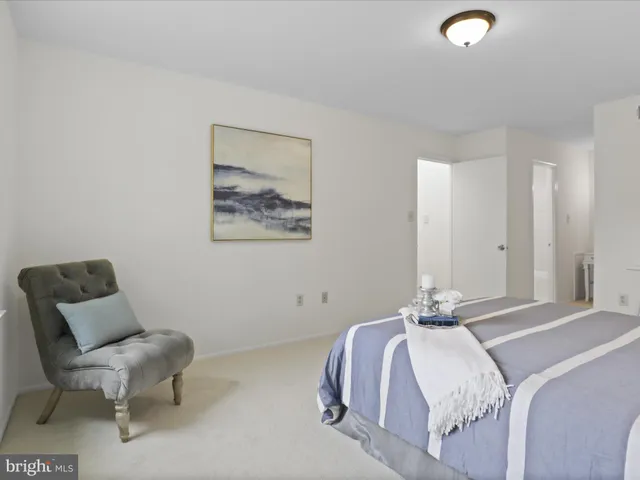 a bedroom with a bed and a chair