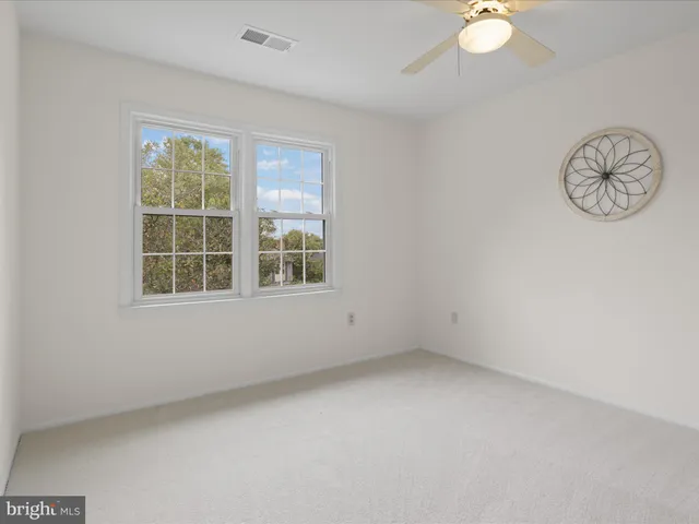 a view of an empty room with a fireplace