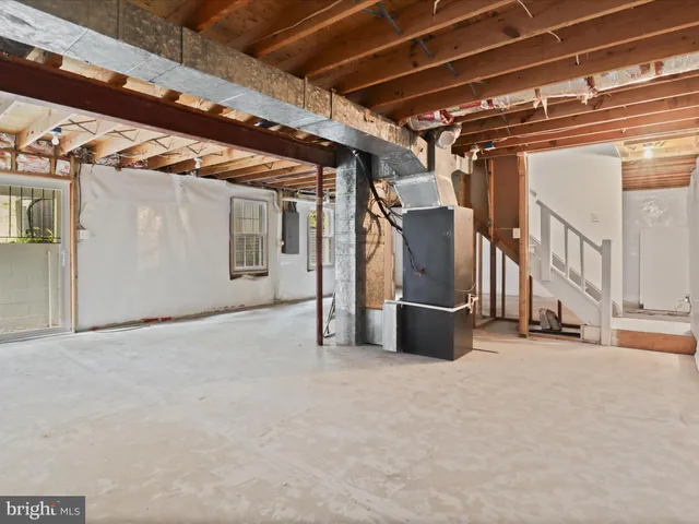 a view of a room with wooden floor and windows