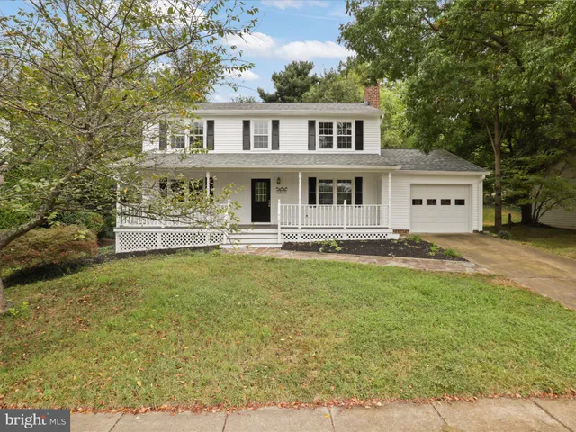 an aerial view of a house with swimming pool and garden