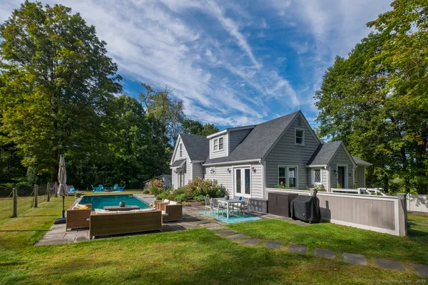 a house view with a sitting space and garden
