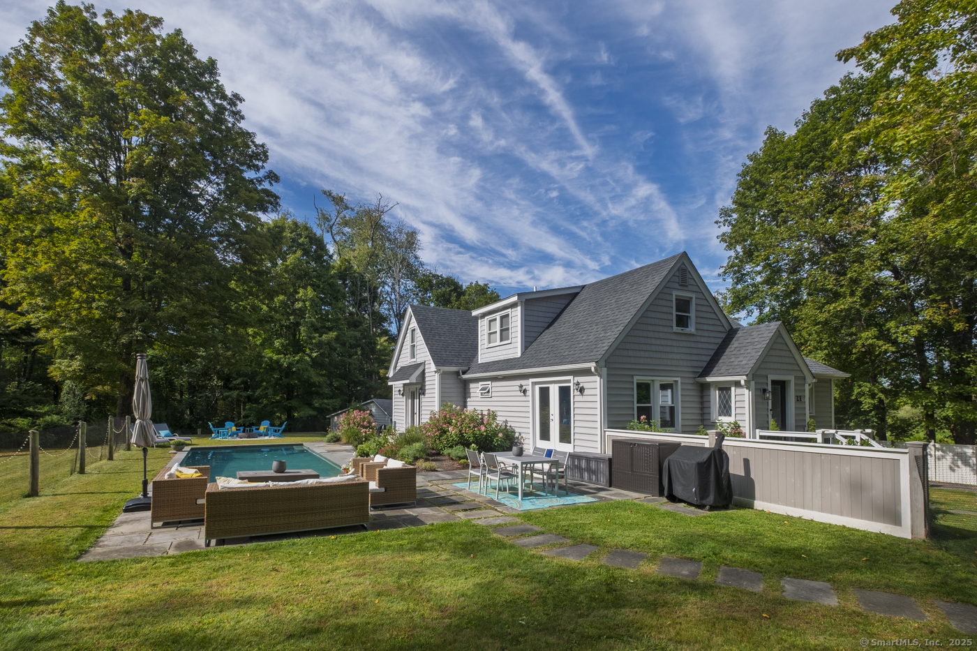 a house view with a sitting space and garden