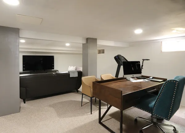 a view of a workspace with furniture