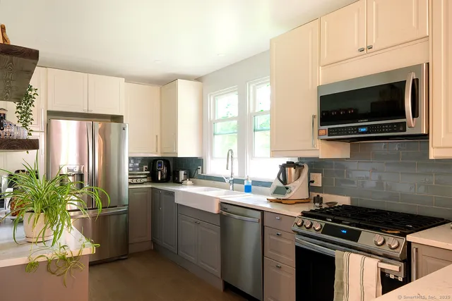 a kitchen with a stove a sink and a microwave