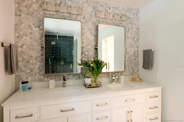 a bathroom with sink and mirror