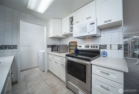 a kitchen with cabinets appliances and a sink