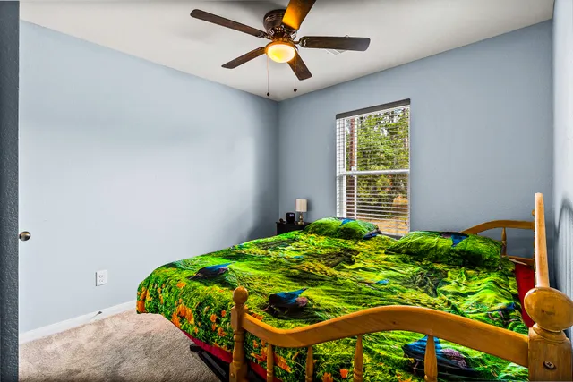 a bed sitting in a bedroom next to a window
